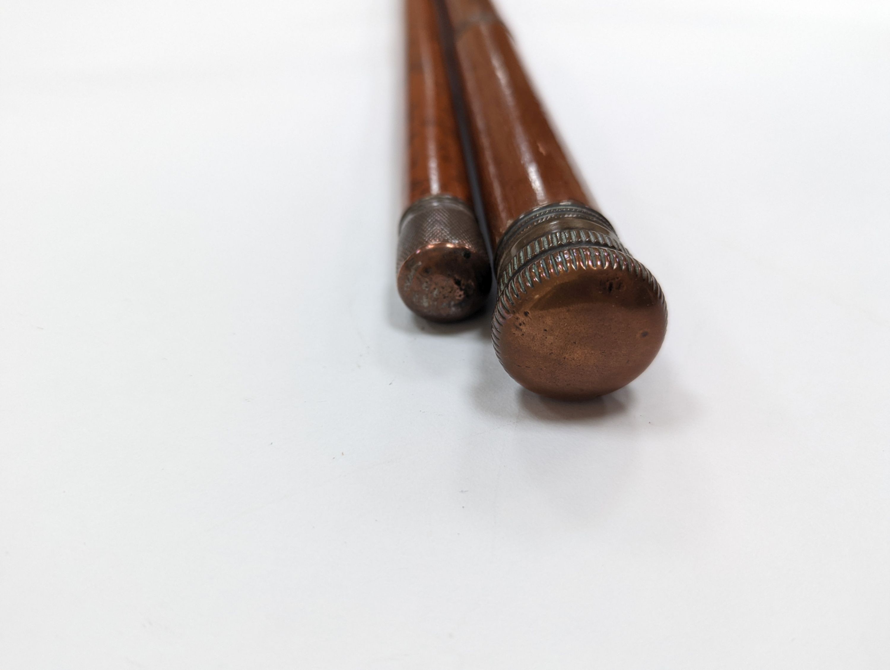 A 19th century novelty ‘pen and pencil’ walking stick together with a glass toddy walking stick